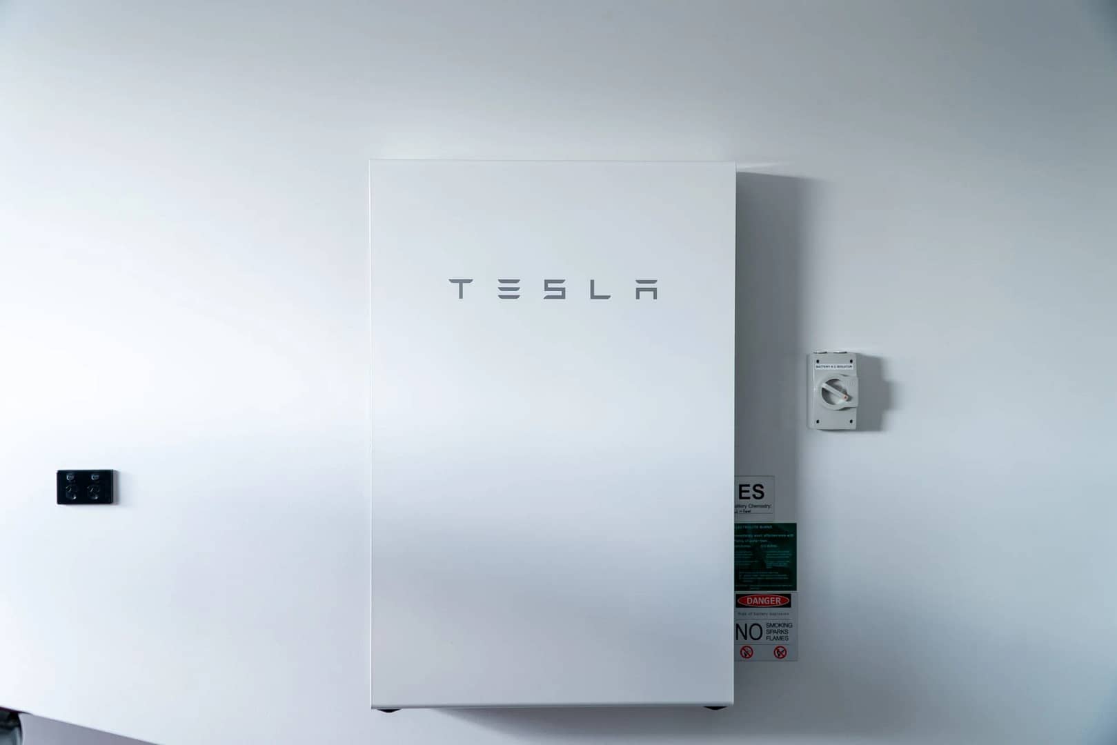Tesla Powerwall 2 mounted against an interior wall, providing efficient energy storage solutions.