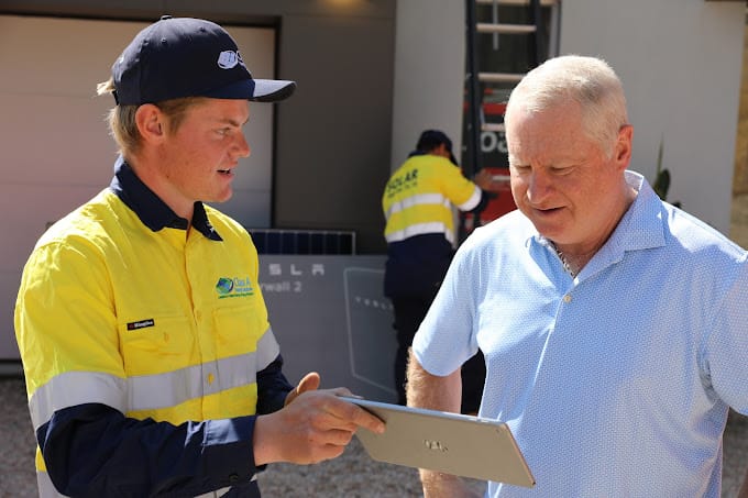 Class A Electrician briefing Chris Dittmar about his solar installation