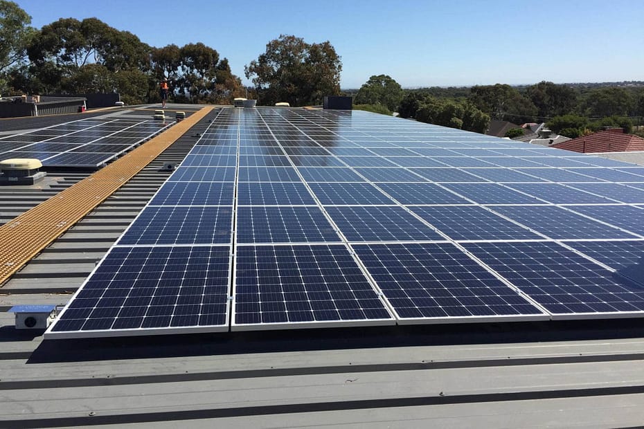 Best solar panels installed on a commercial rooftop in Adelaide under clear blue skies